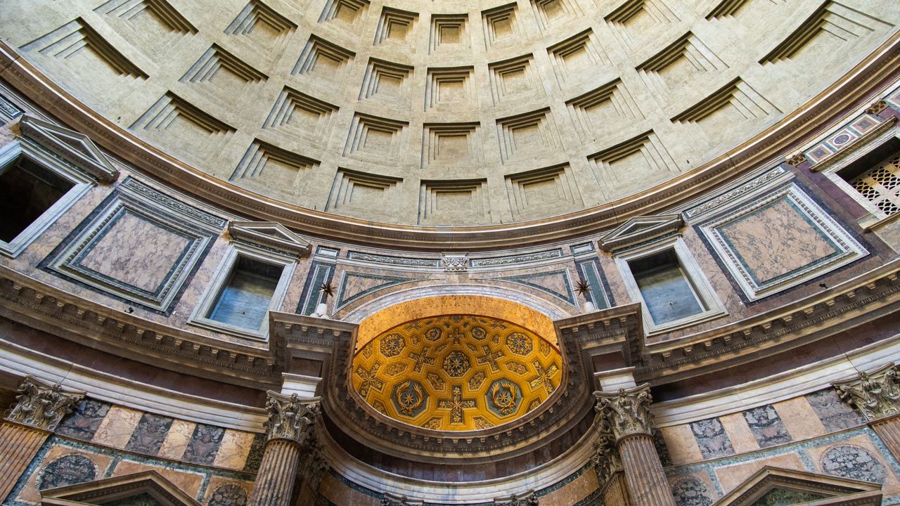 The Pantheon interior: the coffered dome, the gilded apse and the coloured marble of the drum