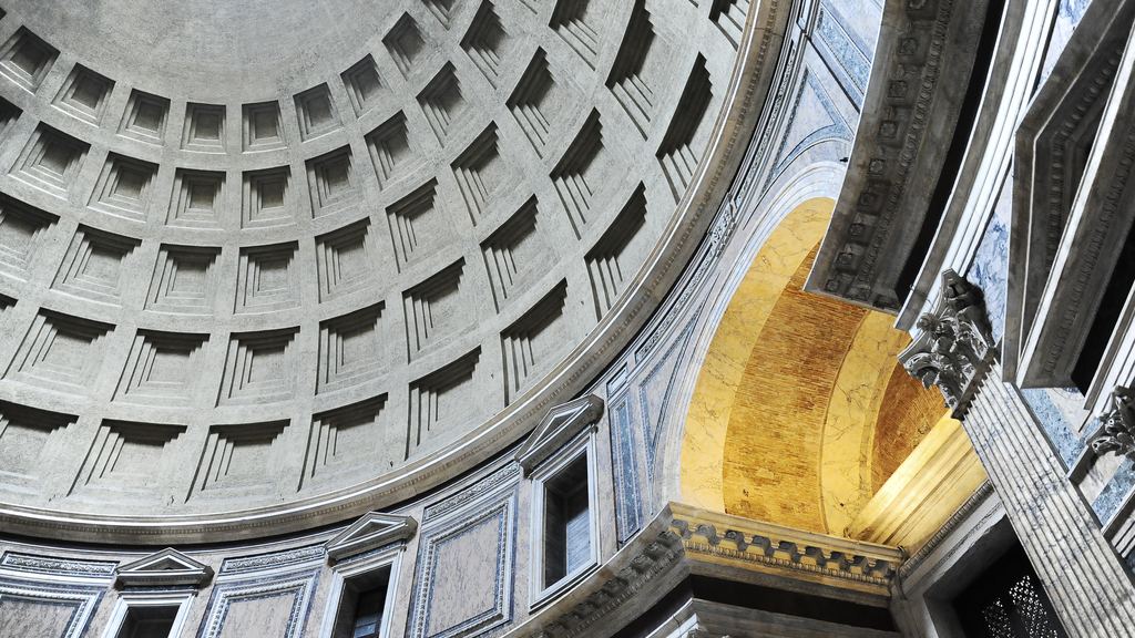 Rings of coffers curving up to the Pantheon's oculus, with sunlight falling across the wall and apse below