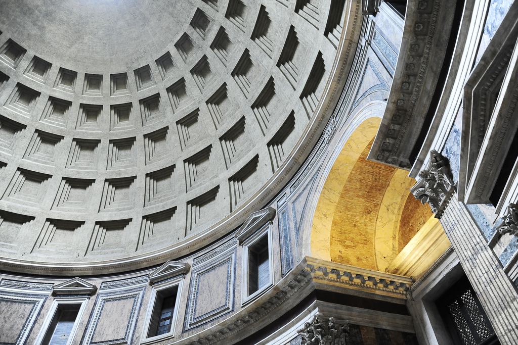 Five rings of coffers curving up to the Pantheon's oculus, with sunlight falling across the apse below