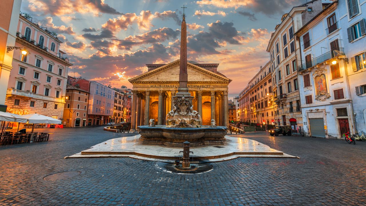 Piazza della Rotonda at sunset, the obelisk and fountain in the centre under a pink and violet sky
