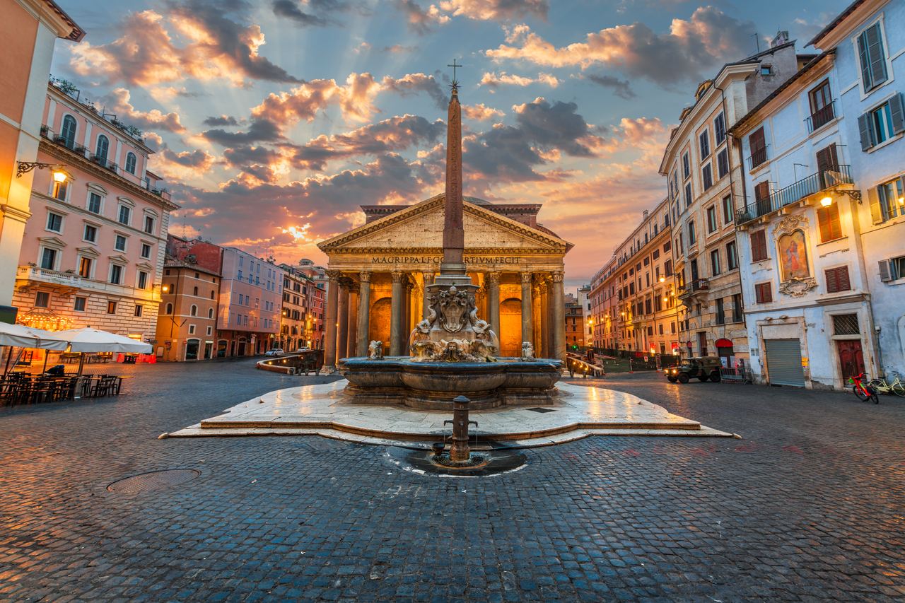 Piazza della Rotonda at sunset, the obelisk and fountain in the centre under a pink and violet sky