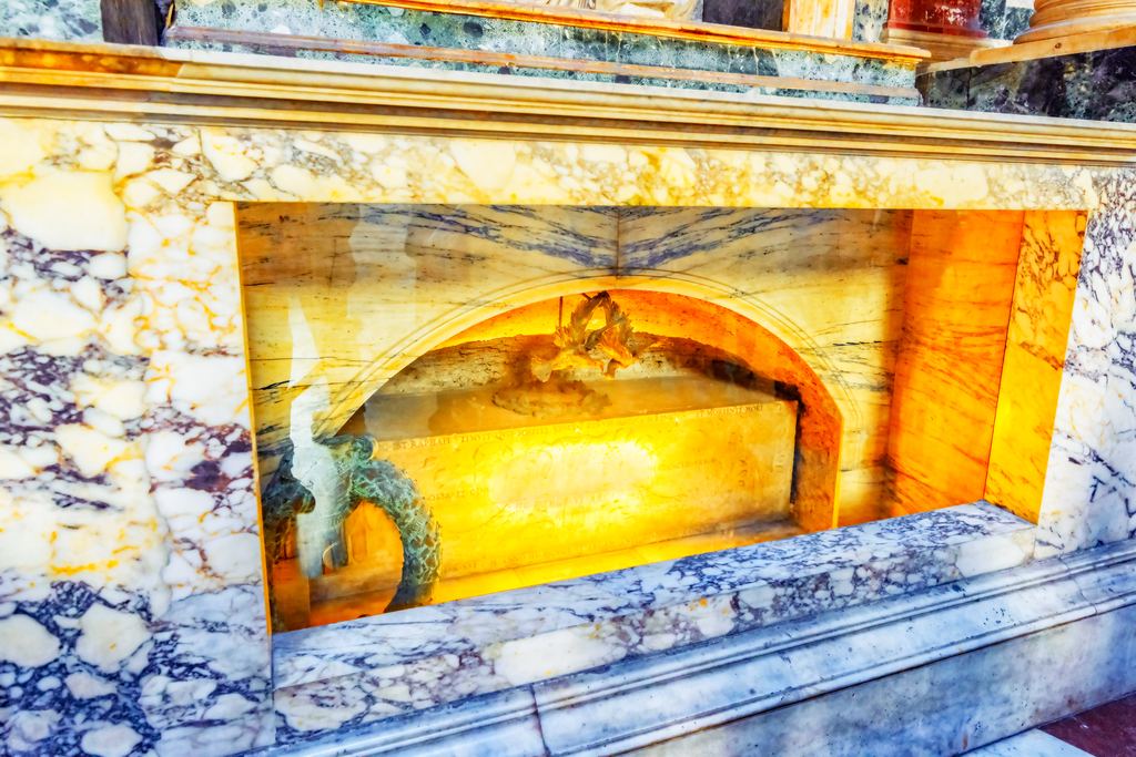 The ancient marble sarcophagus of Raphael's tomb inside the Pantheon, set in an aedicule of coloured marble