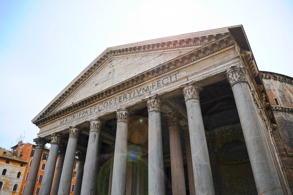 The Pantheon's monolithic granite columns in perspective, their Corinthian capitals and the deep shade between them