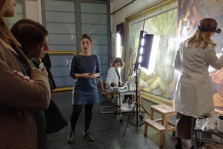 The restorers at work as the guide explains the process