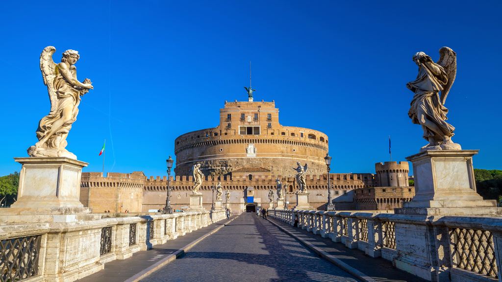 Two of Bernini's angels on Ponte Sant'Angelo framing Castel Sant'Angelo under a blue sky